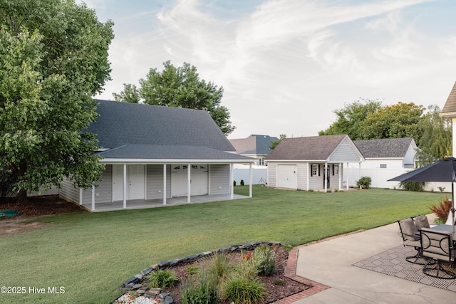 4409 Pinehurst Dr N, Wilson, NC 27896 - view of yard featuring an outbuilding, a patio area, a garage, and covered porch