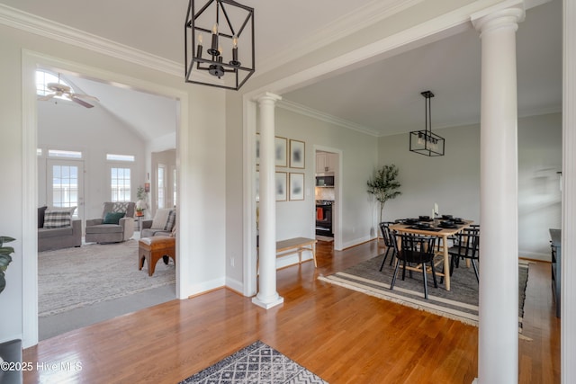 4409 Pinehurst Dr N, Wilson, NC 27896 - dining space featuring ornate columns, wood finished floors, ornamental molding, a ceiling fan, and a chandelier