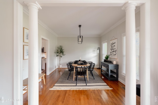 4409 Pinehurst Dr N, Wilson, NC 27896 - dining space featuring decorative columns, dark wood finished floors, and crown molding