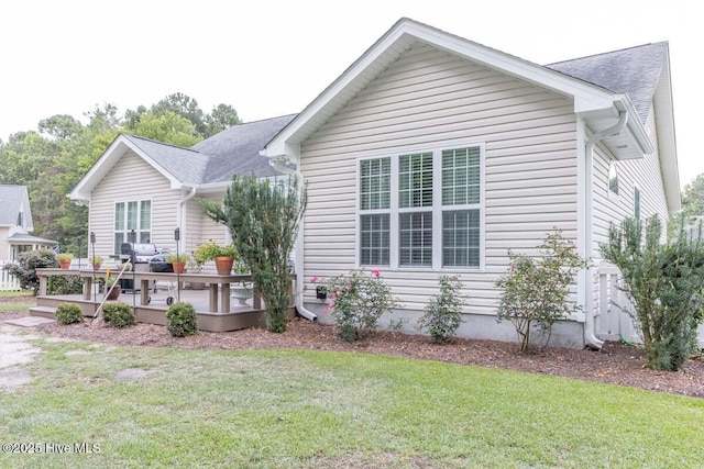 1113 Palmer Way, Morehead City, NC 28557 - view of front of property featuring a wooden deck, a front yard, and a shingled roof