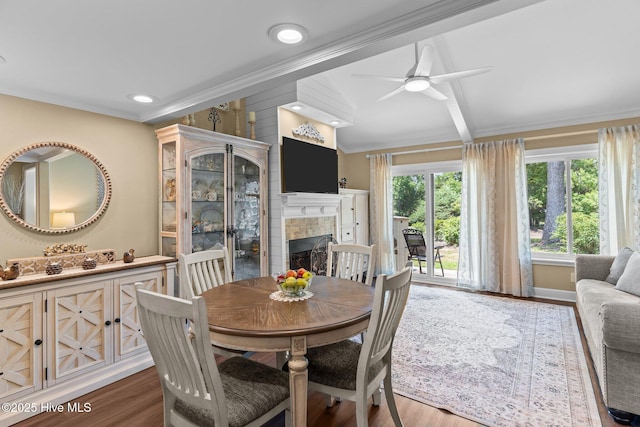 241 Saint James Ct, Wilmington, NC 28409 - dining room featuring a fireplace, ornamental molding, ceiling fan, wood finished floors, and lofted ceiling