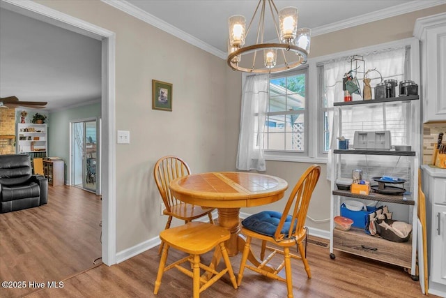 198 Verona Rd, Jacksonville, NC 28540 - dining room with a chandelier, ornamental molding, wood finished floors, and ceiling fan