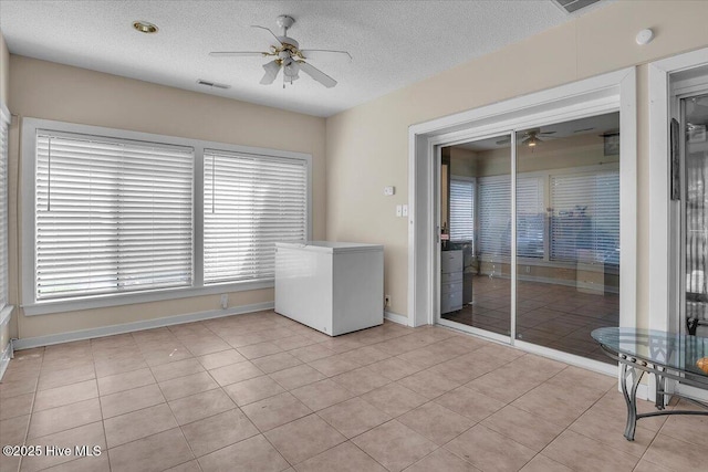198 Verona Rd, Jacksonville, NC 28540 - spare room featuring a ceiling fan, a textured ceiling, light tile patterned flooring, and a smoke detector