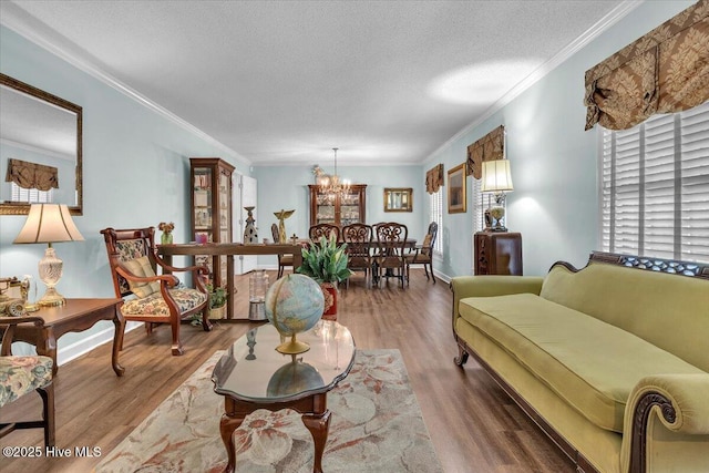 198 Verona Rd, Jacksonville, NC 28540 - living room with a chandelier, wood finished floors, ornamental molding, and a textured ceiling