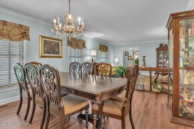 198 Verona Rd, Jacksonville, NC 28540 - dining room featuring a chandelier, light wood-type flooring, and crown molding