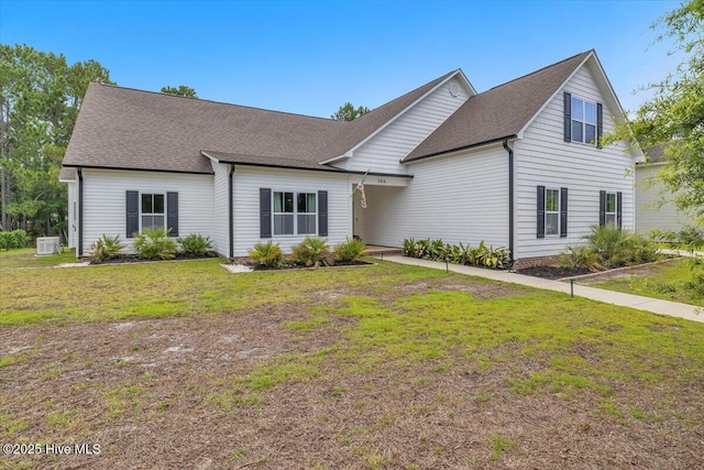 106 Roughleaf Trl, Hampstead, NC 28443 - view of front of house featuring a front lawn and a shingled roof