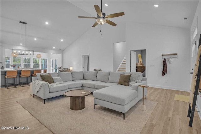 106 Roughleaf Trl, Hampstead, NC 28443 - living room featuring high vaulted ceiling, ceiling fan, light wood-style floors, recessed lighting, and stairway