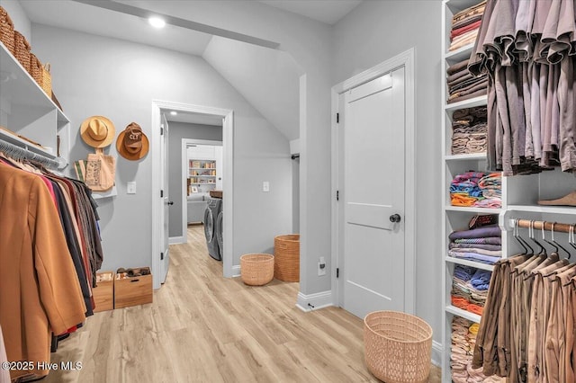 106 Roughleaf Trl, Hampstead, NC 28443 - spacious closet featuring separate washer and dryer, light wood-style flooring, and lofted ceiling