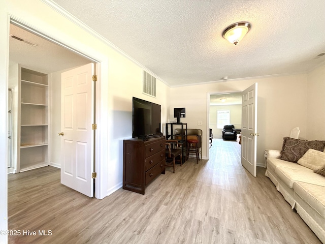 226 Community Rd, Lillington, NC 27546 - living room with light wood-type flooring, ornamental molding, an office area, a textured ceiling, and built in shelves
