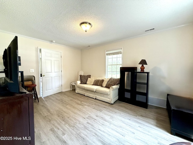 226 Community Rd, Lillington, NC 27546 - living room featuring ornamental molding, light wood-style floors, and a textured ceiling