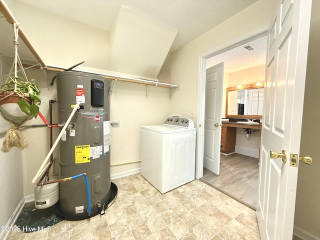 226 Community Rd, Lillington, NC 27546 - laundry area with heat pump water heater and washer / dryer