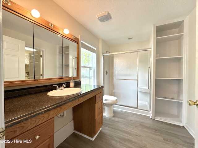 226 Community Rd, Lillington, NC 27546 - full bath with vanity, a shower stall, wood finished floors, and a textured ceiling