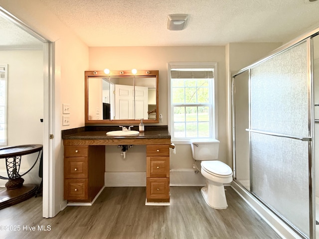 226 Community Rd, Lillington, NC 27546 - full bathroom featuring wood finished floors, a textured ceiling, a stall shower, and vanity