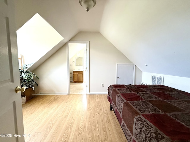 226 Community Rd, Lillington, NC 27546 - bedroom featuring wood finished floors, lofted ceiling, and connected bathroom