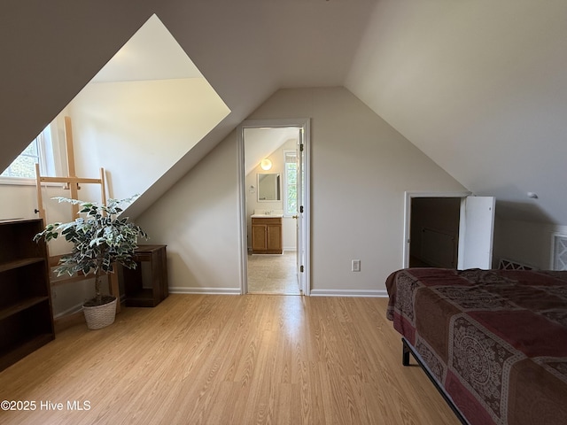 226 Community Rd, Lillington, NC 27546 - bedroom with wood finished floors, lofted ceiling, and ensuite bath