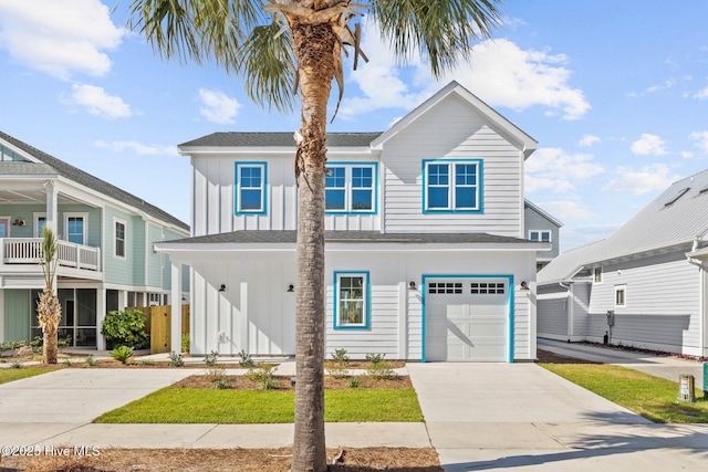 1320 Searay Ln, Carolina Beach, NC 28428 - view of front facade featuring an attached garage, driveway, and board and batten siding