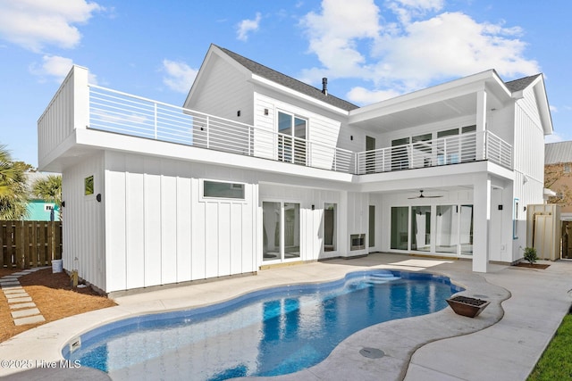 1320 Searay Ln, Carolina Beach, NC 28428 - rear view of house featuring a balcony, a ceiling fan, a patio, and board and batten siding