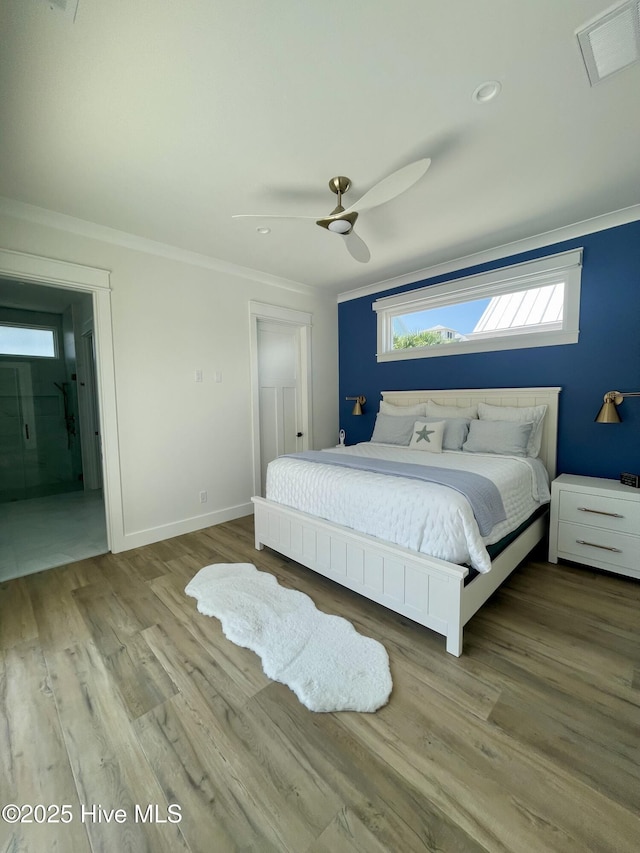 1320 Searay Ln, Carolina Beach, NC 28428 - bedroom featuring crown molding, wood finished floors, ceiling fan, and ensuite bathroom