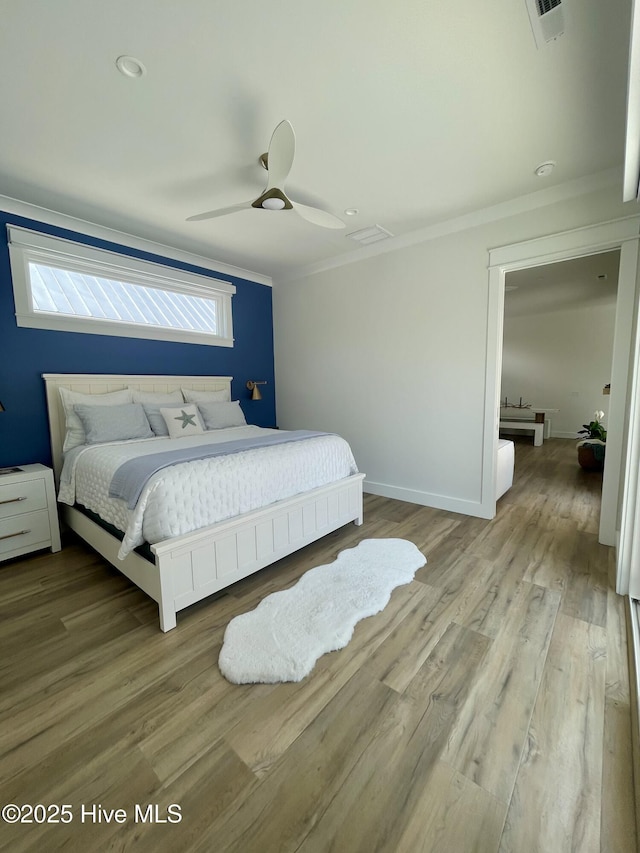 1320 Searay Ln, Carolina Beach, NC 28428 - bedroom featuring crown molding, wood finished floors, and a ceiling fan