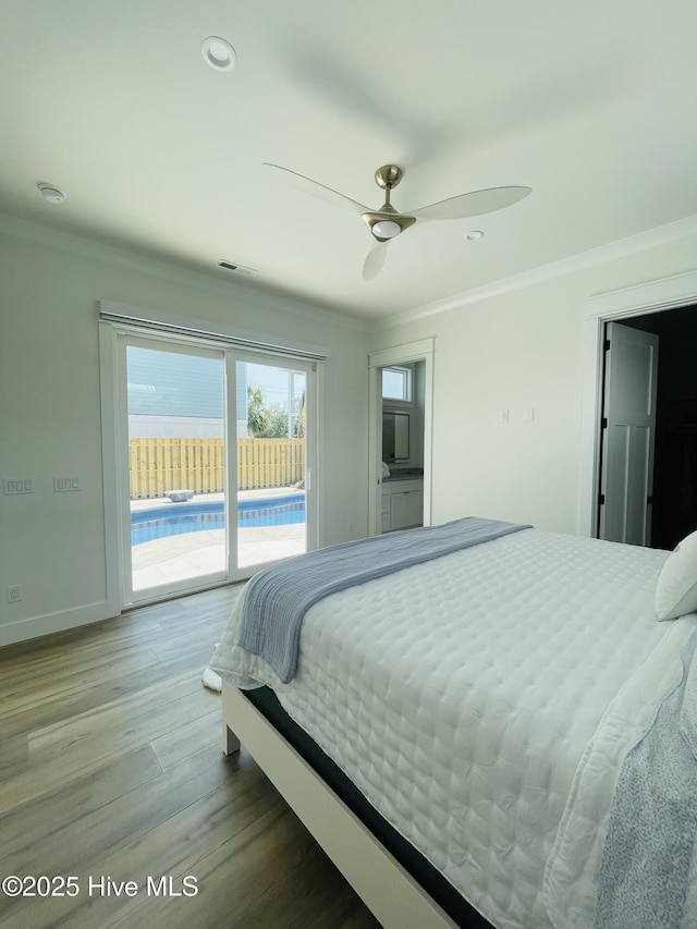 1320 Searay Ln, Carolina Beach, NC 28428 - bedroom featuring access to exterior, crown molding, wood finished floors, recessed lighting, and ceiling fan