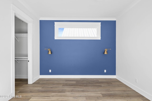 1320 Searay Ln, Carolina Beach, NC 28428 - unfurnished bedroom with a closet, ornamental molding, and wood finished floors