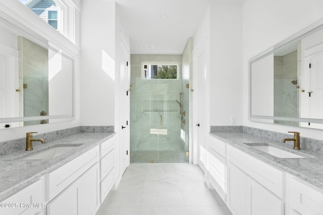 1320 Searay Ln, Carolina Beach, NC 28428 - bathroom with marble look tile flooring, a marble finish shower, and two vanities