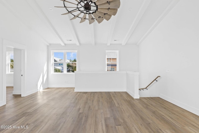 1320 Searay Ln, Carolina Beach, NC 28428 - unfurnished living room featuring beamed ceiling, ceiling fan, and wood finished floors