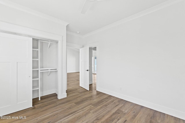 1320 Searay Ln, Carolina Beach, NC 28428 - unfurnished bedroom with ornamental molding, wood finished floors, a closet, and a ceiling fan