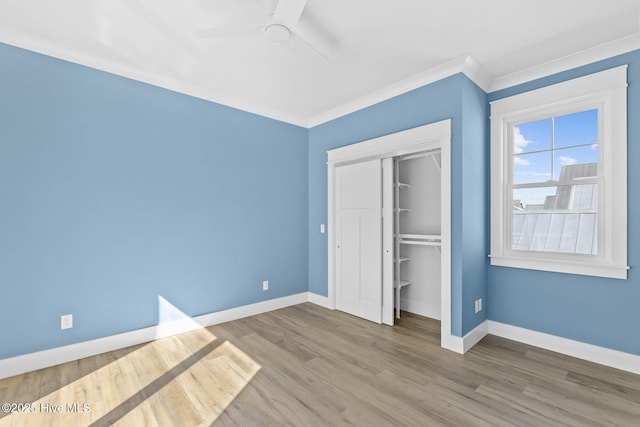 1320 Searay Ln, Carolina Beach, NC 28428 - unfurnished bedroom featuring a closet, wood finished floors, ornamental molding, and a ceiling fan