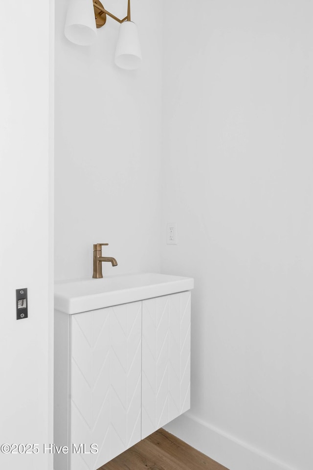 1320 Searay Ln, Carolina Beach, NC 28428 - bathroom featuring wood finished floors and a sink