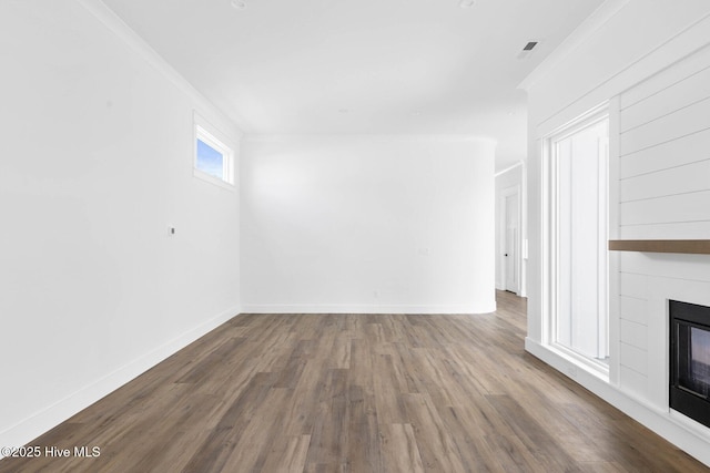1320 Searay Ln, Carolina Beach, NC 28428 - unfurnished living room featuring a glass covered fireplace and wood finished floors
