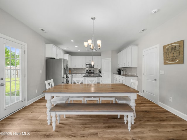 510 Transom Way, Sneads Ferry, NC 28460 - dining space featuring a chandelier, wood finished floors, and recessed lighting