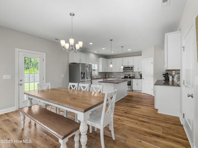 510 Transom Way, Sneads Ferry, NC 28460 - dining area featuring healthy amount of natural light, wood finished floors, a chandelier, and recessed lighting