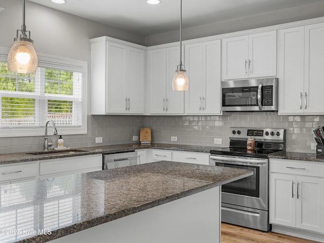 510 Transom Way, Sneads Ferry, NC 28460 - kitchen featuring appliances with stainless steel finishes, white cabinets, dark stone countertops, backsplash, and recessed lighting