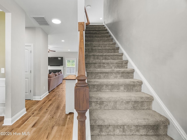 510 Transom Way, Sneads Ferry, NC 28460 - staircase featuring wood finished floors, ceiling fan, and a fireplace