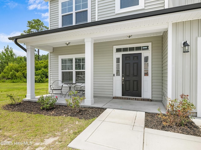 510 Transom Way, Sneads Ferry, NC 28460 - view of exterior entry with board and batten siding, covered porch, and a lawn