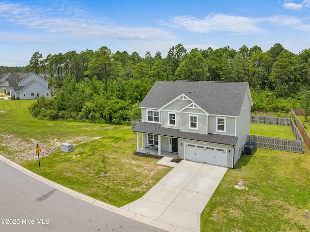 510 Transom Way, Sneads Ferry, NC 28460 - view of front of home with a porch, roof with shingles, a garage, concrete driveway, and a forest view