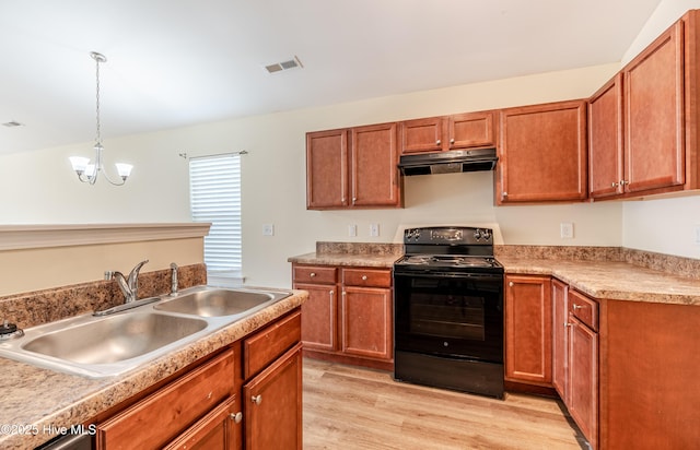 3021 Evening Rd, Castle Hayne, NC 28429 - kitchen with black range with electric stovetop, under cabinet range hood, light wood-style flooring, decorative light fixtures, and brown cabinets