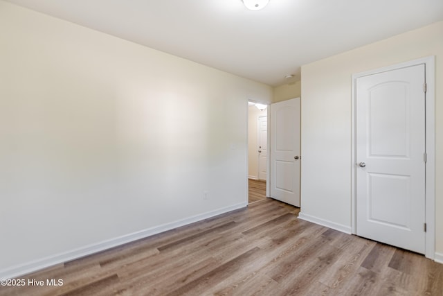 3021 Evening Rd, Castle Hayne, NC 28429 - unfurnished bedroom featuring light wood-style flooring and baseboards