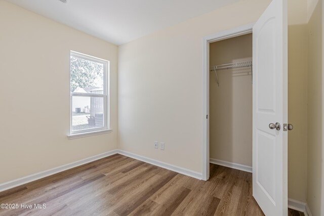 3021 Evening Rd, Castle Hayne, NC 28429 - unfurnished bedroom featuring wood finished floors and a closet