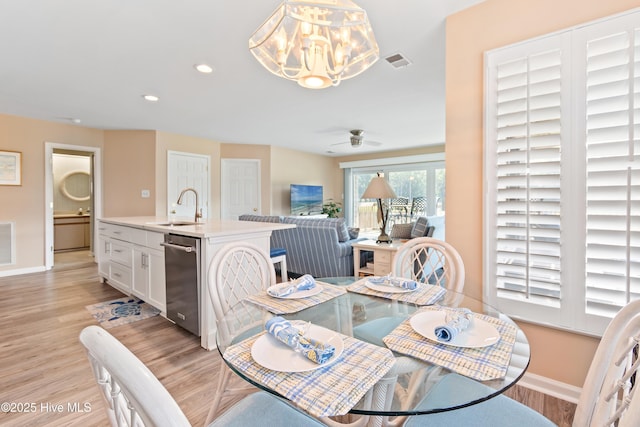 811 Colony Pl # D, Sunset Beach, NC 28468 - dining area with light wood-style floors, a chandelier, recessed lighting, and a ceiling fan