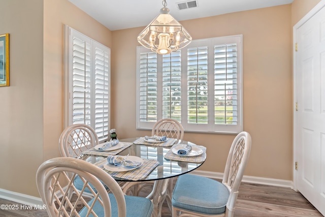 811 Colony Pl # D, Sunset Beach, NC 28468 - dining room with a chandelier and wood finished floors