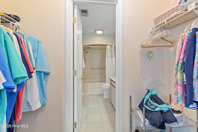 811 Colony Pl # D, Sunset Beach, NC 28468 - walk in closet featuring tile patterned flooring and arched walkways