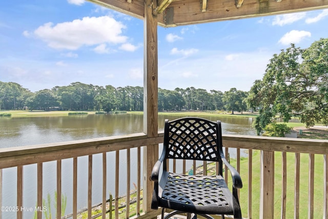 811 Colony Pl # D, Sunset Beach, NC 28468 - wooden deck with a water view and view of scattered trees
