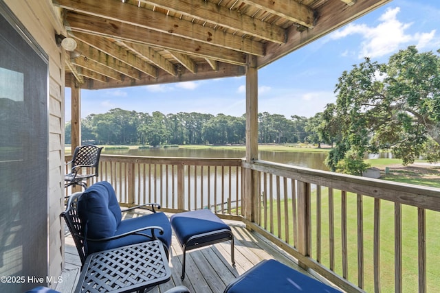 811 Colony Pl # D, Sunset Beach, NC 28468 - wooden terrace featuring a water view, a lawn, and view of scattered trees