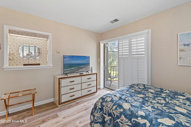 811 Colony Pl # D, Sunset Beach, NC 28468 - bedroom with light wood finished floors and access to outside