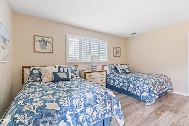 811 Colony Pl # D, Sunset Beach, NC 28468 - bedroom featuring wood finished floors and baseboards