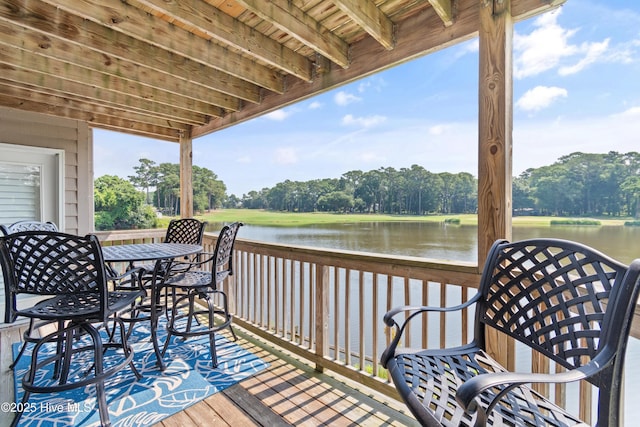 811 Colony Pl # D, Sunset Beach, NC 28468 - deck with a water view, view of scattered trees, and outdoor dining space