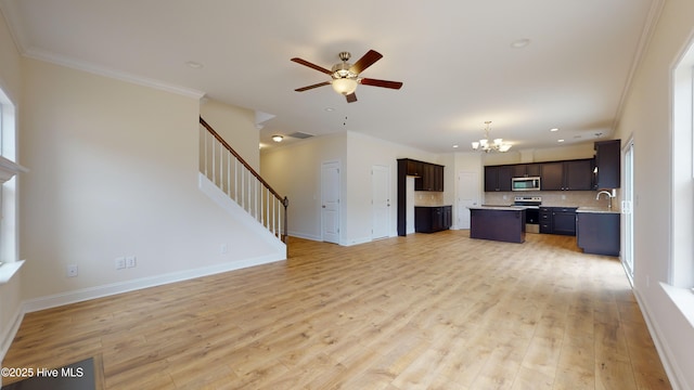 341 Oleander Dr, Greenville, NC 27858 - unfurnished living room with a chandelier, ceiling fan, stairs, light wood-style flooring, and ornamental molding