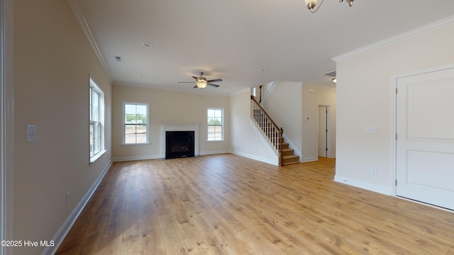 341 Oleander Dr, Greenville, NC 27858 - unfurnished living room featuring crown molding, stairs, ceiling fan, light wood-style flooring, and a fireplace